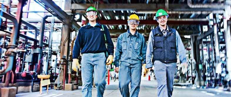 Maintenance technicians walking through an industrial plant