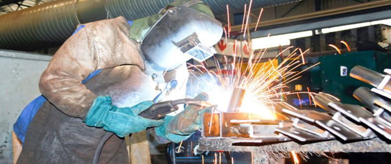 Welder fabricating steel parts