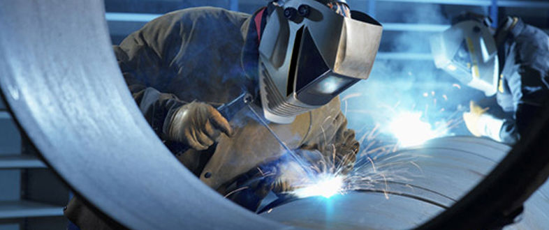 Welder working inside a large steel shell